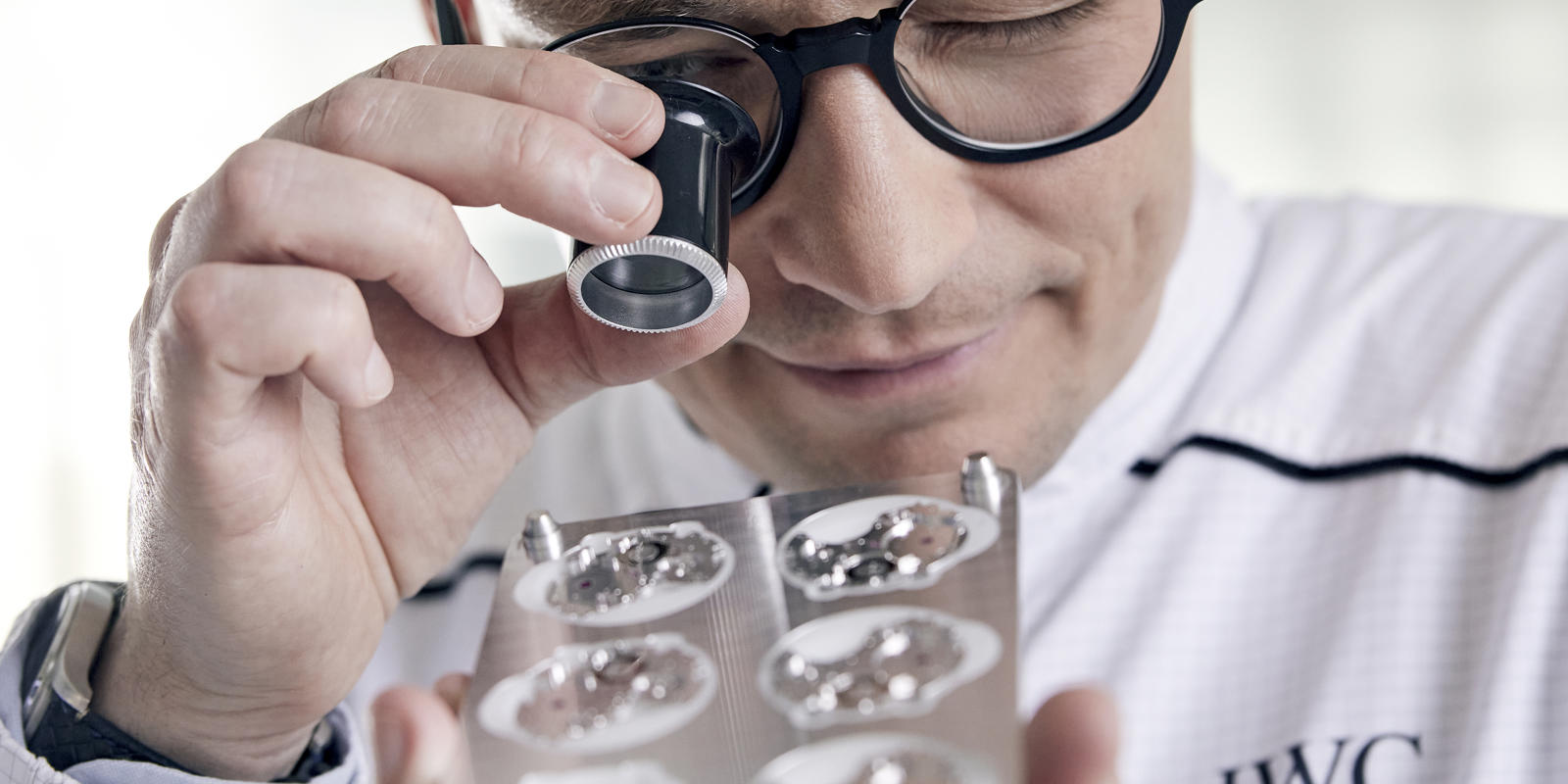 a person looking through a microscope