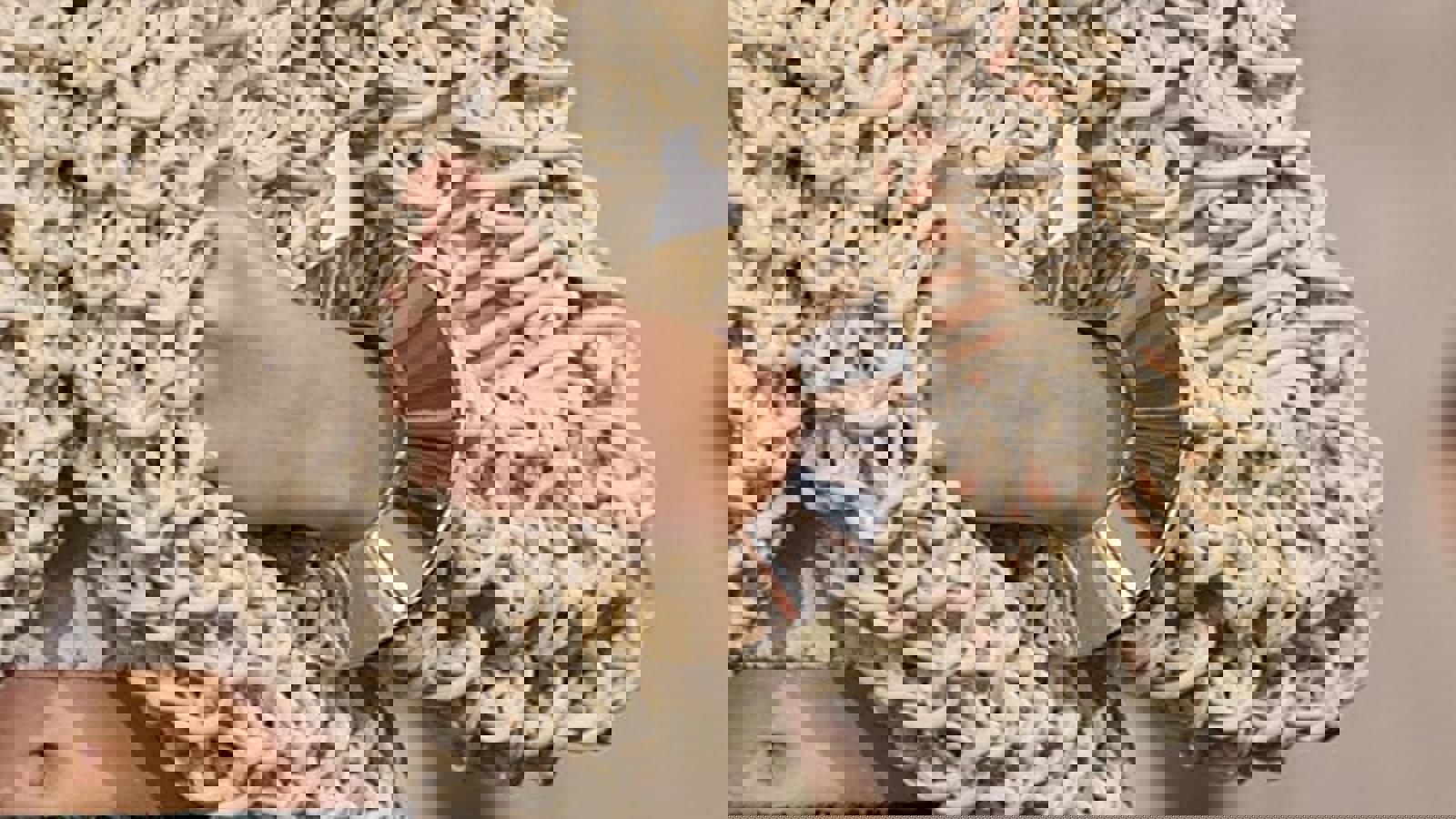 a person wearing a white knitted sweater