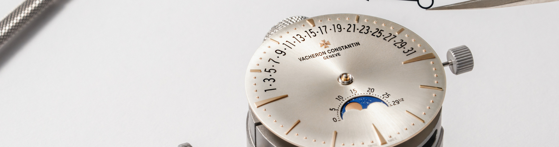 a silver and gold watch dial