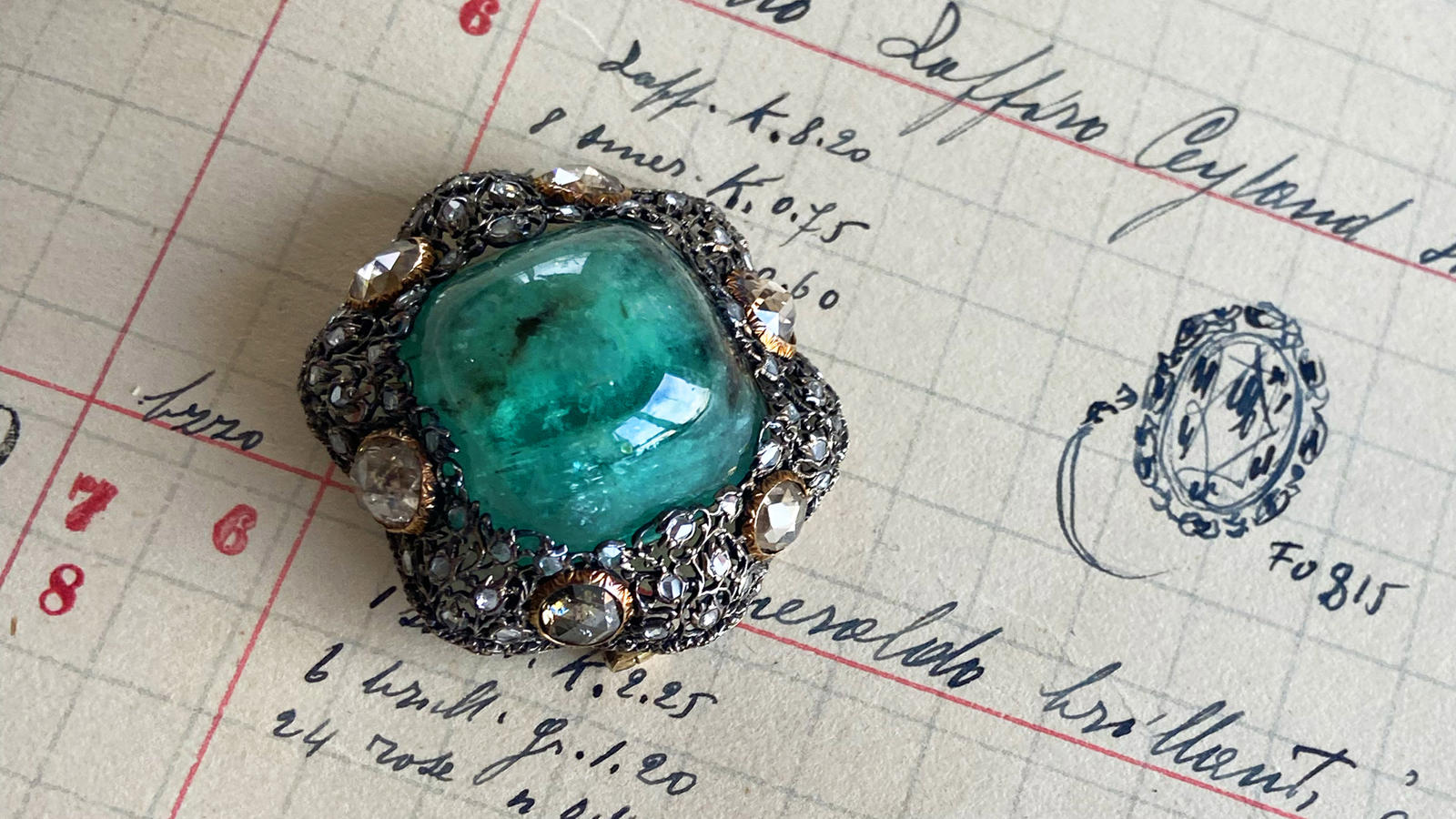 a green stone on a piece of paper