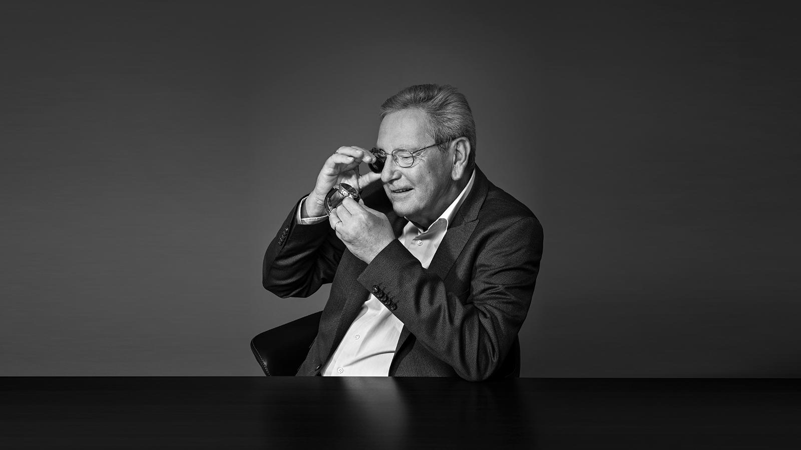 a person in a suit looking through a telescope