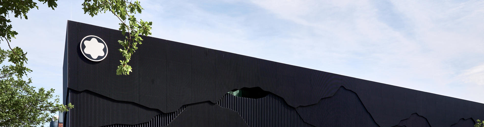 a black building with a white logo on the side