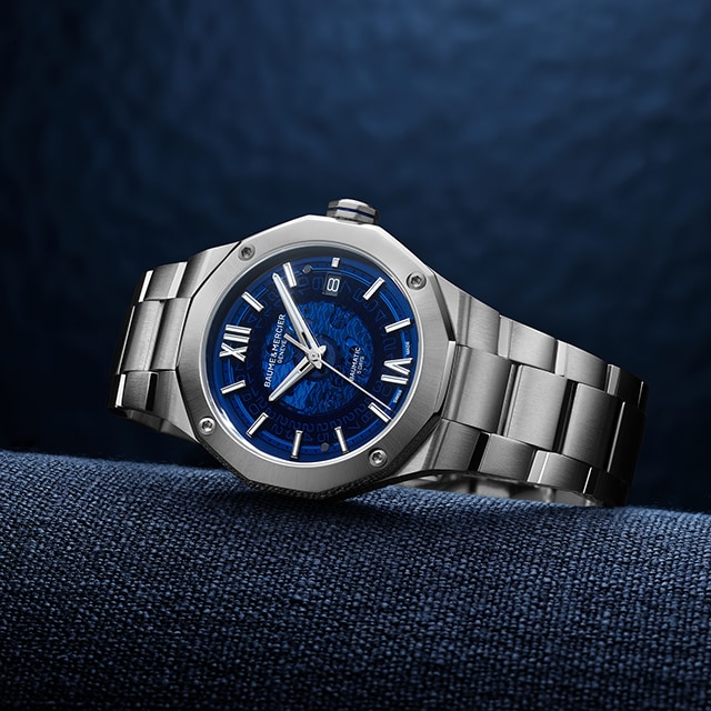 a silver watch with blue face