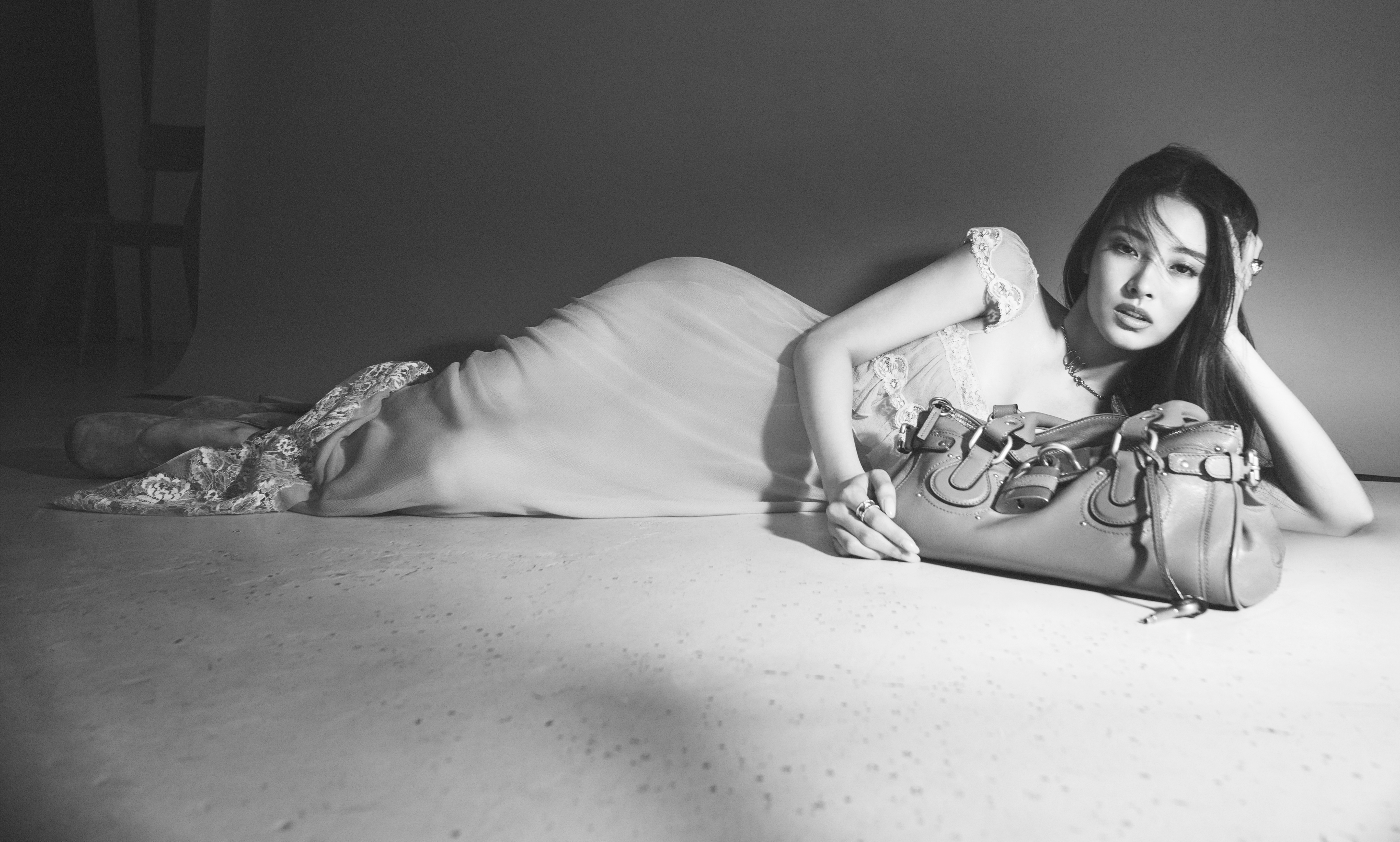 a person lying on the floor holding a purse