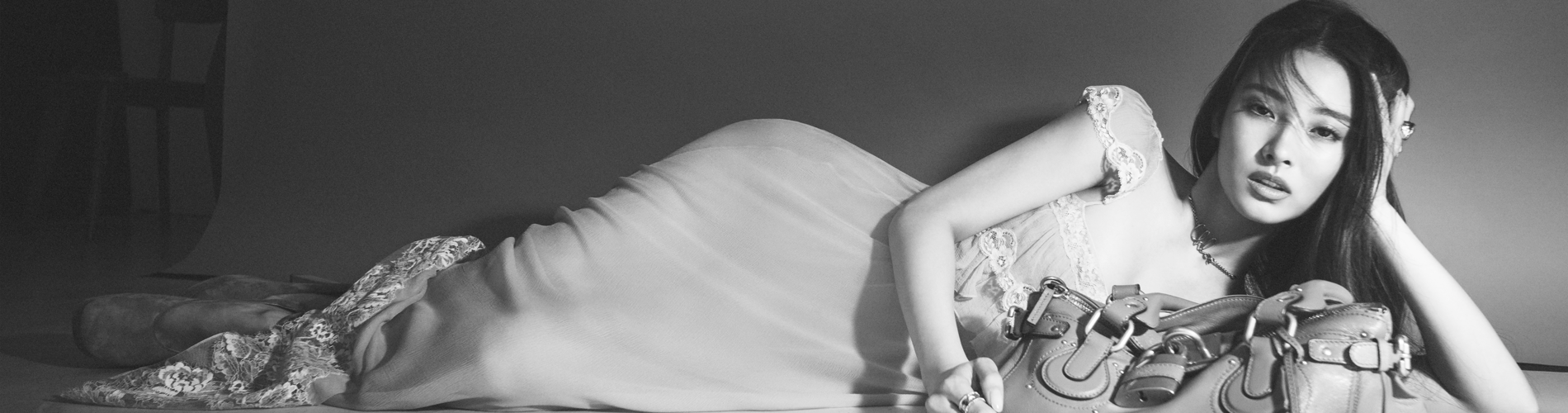 a person lying on the floor holding a purse