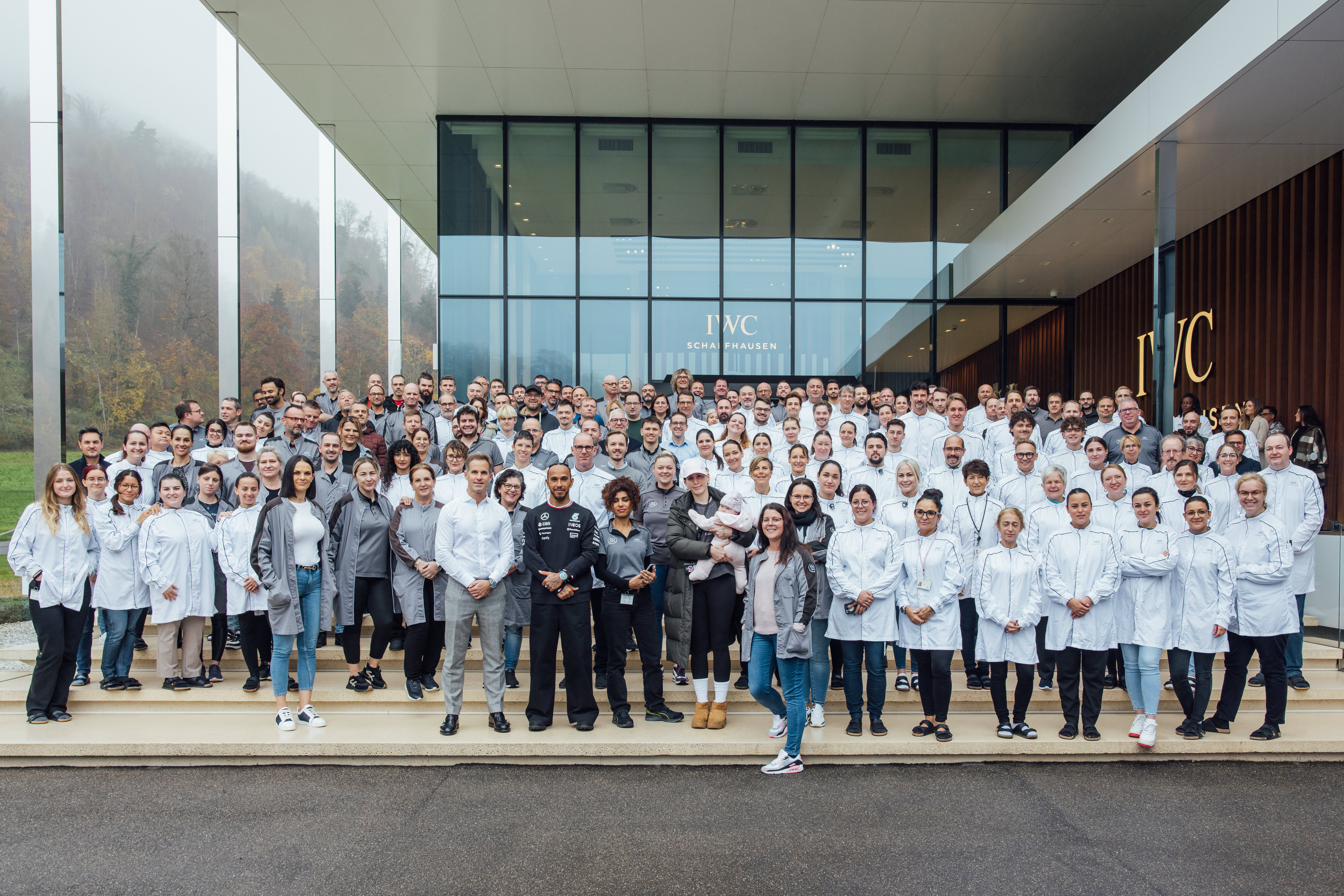 a group of people in white coats posing for a photo