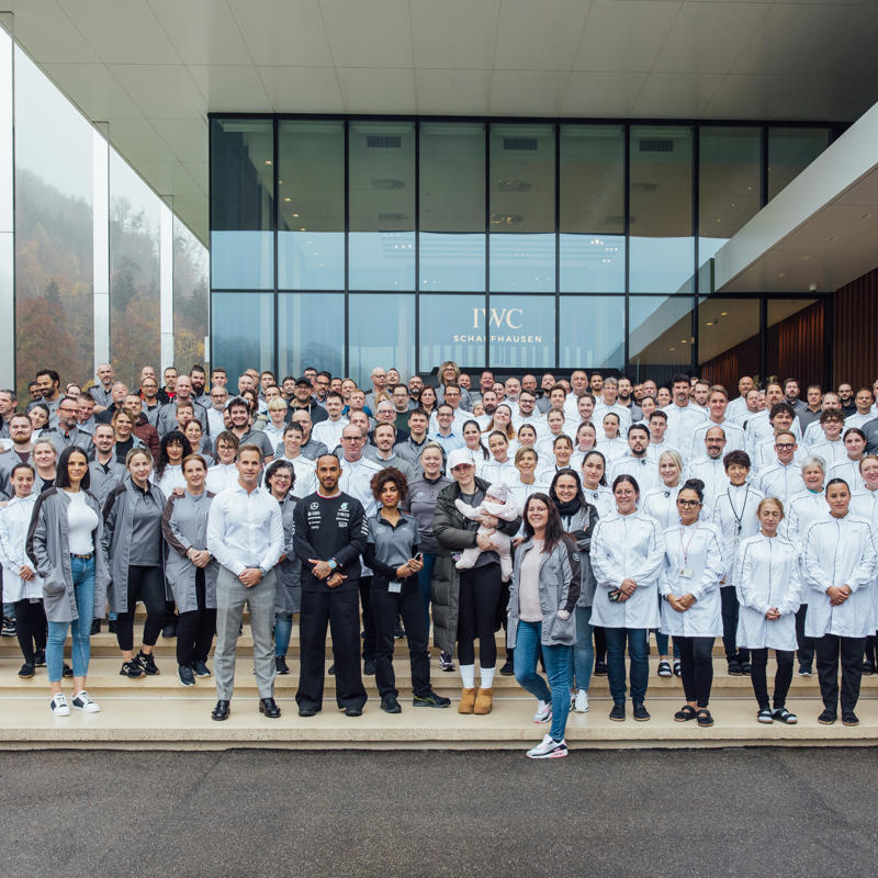 a group of people in white coats posing for a photo