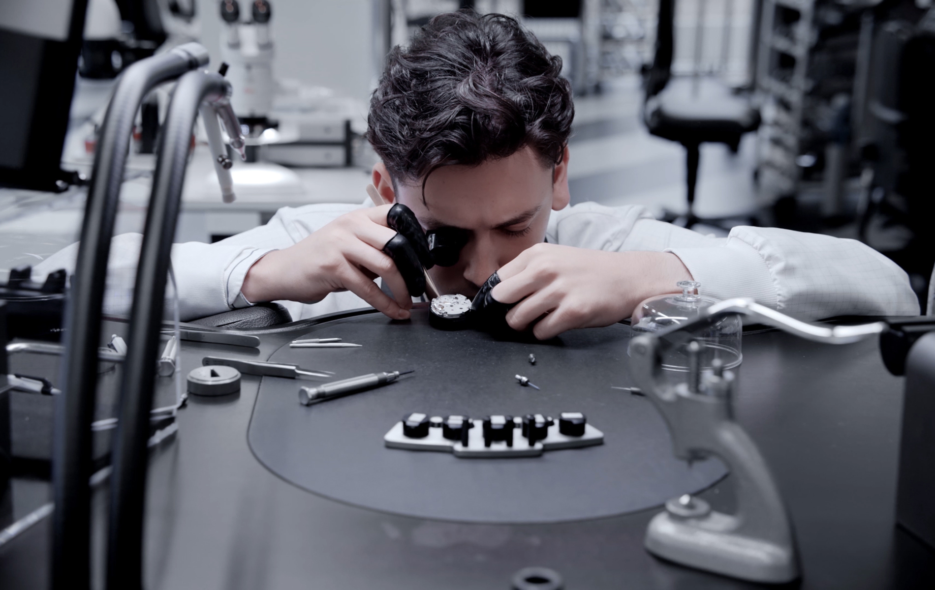 a person looking through a microscope