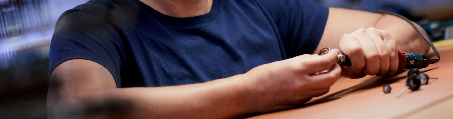 a person wearing glasses and looking down at a lamp