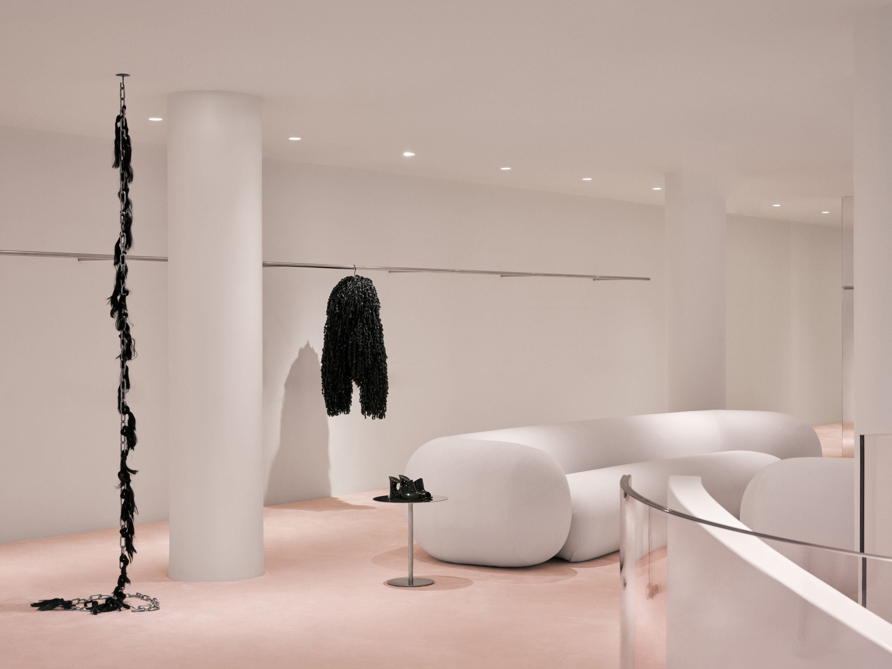 a room with white columns and a black scarf on a hook